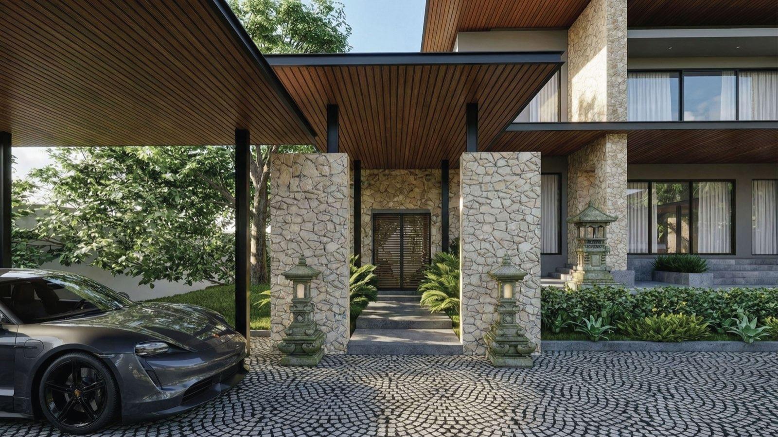 Entry canopy at Anyara Hill framed by stone piers and Balinese stone lanterns