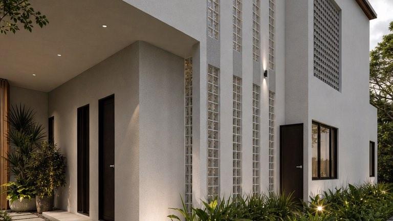 Entry porch at the Bangi house with tall glass-block fins, planting and stepping stones