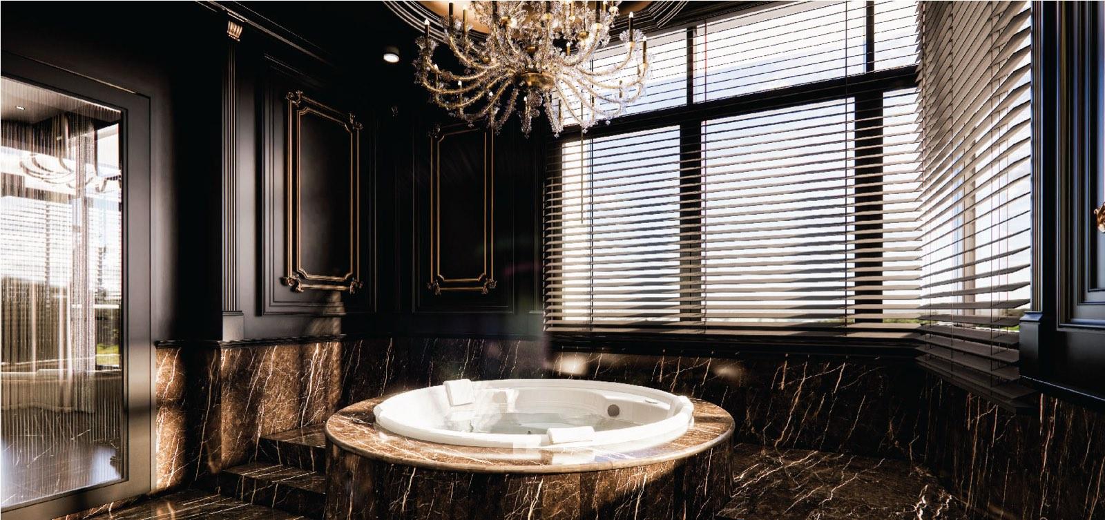 Bathroom of the Bukit Gambir residence with a round jacuzzi tub on a brown marble plinth beneath a chandelier