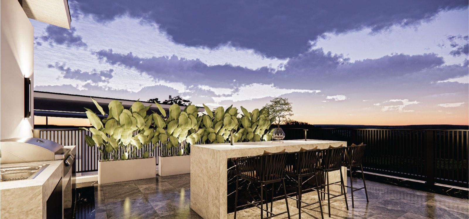 Rooftop terrace of the Bukit Gambir residence at dusk, with an outdoor kitchen, stone bar counter and planted screen facing the strait