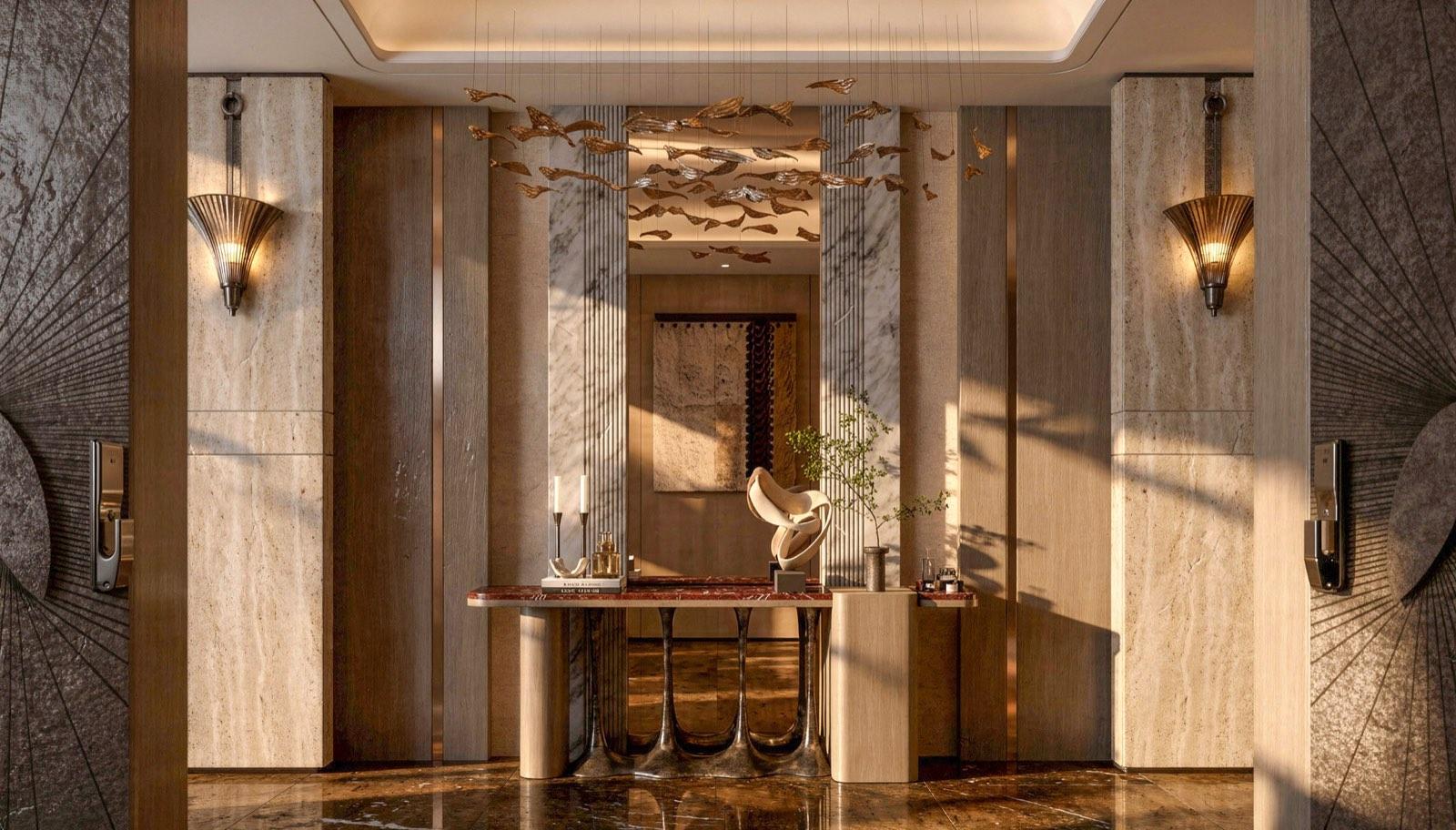 Private-lift foyer at Four Seasons Residence Bangalore in travertine and book-matched marble, with a cast bronze bird installation overhead