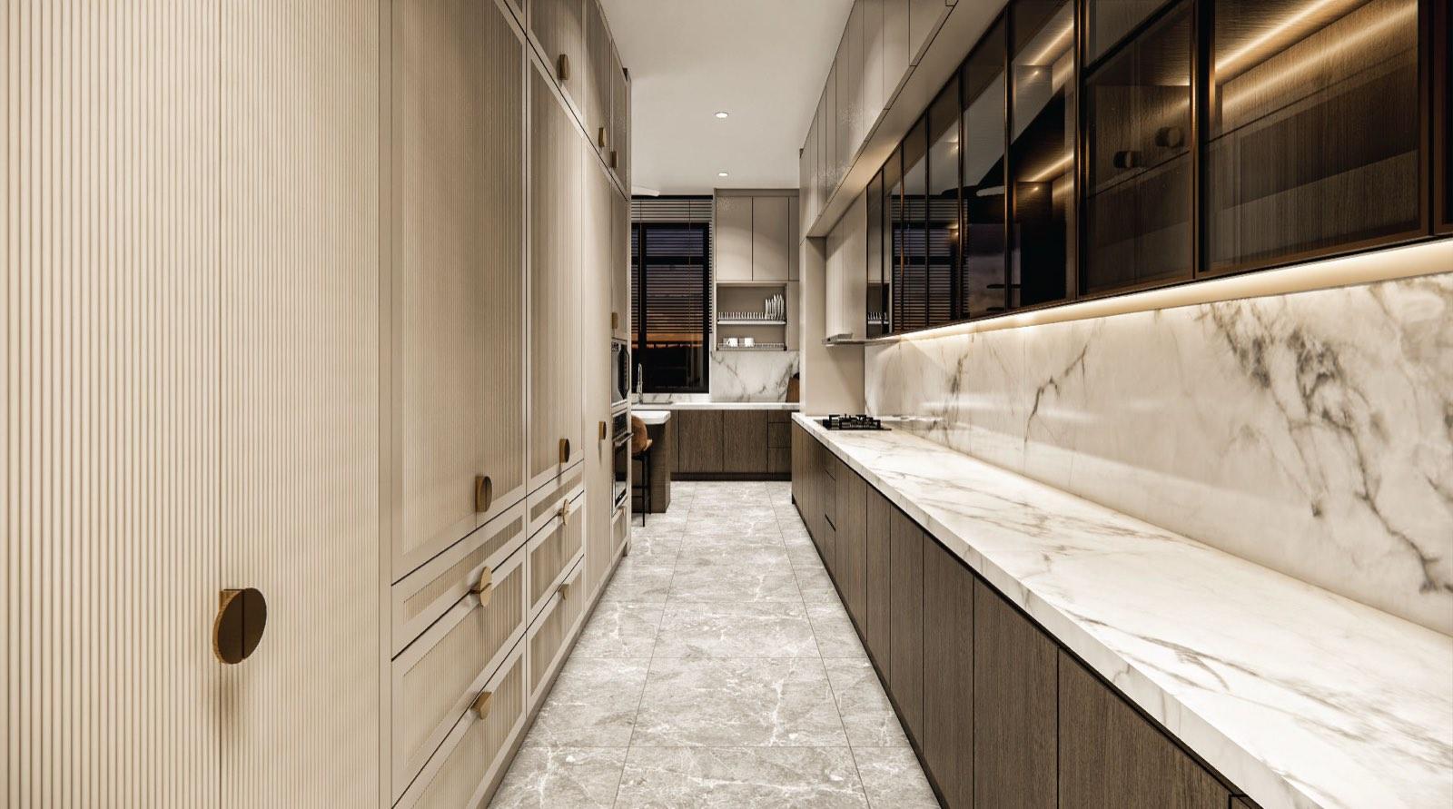 Galley wet kitchen of the Johor Bahru residence with fluted cream cabinetry and a marble worktop lit from above