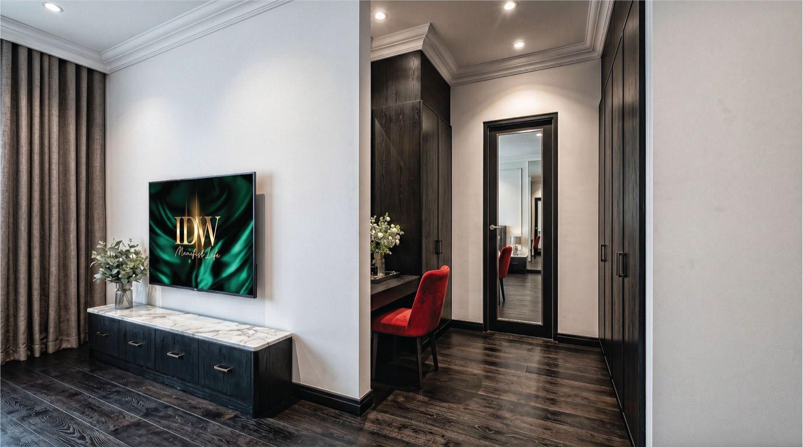 Bedroom suite at the KGSAAS villa in Shah Alam with dark timber wardrobes, a dressing desk and marble-topped media console