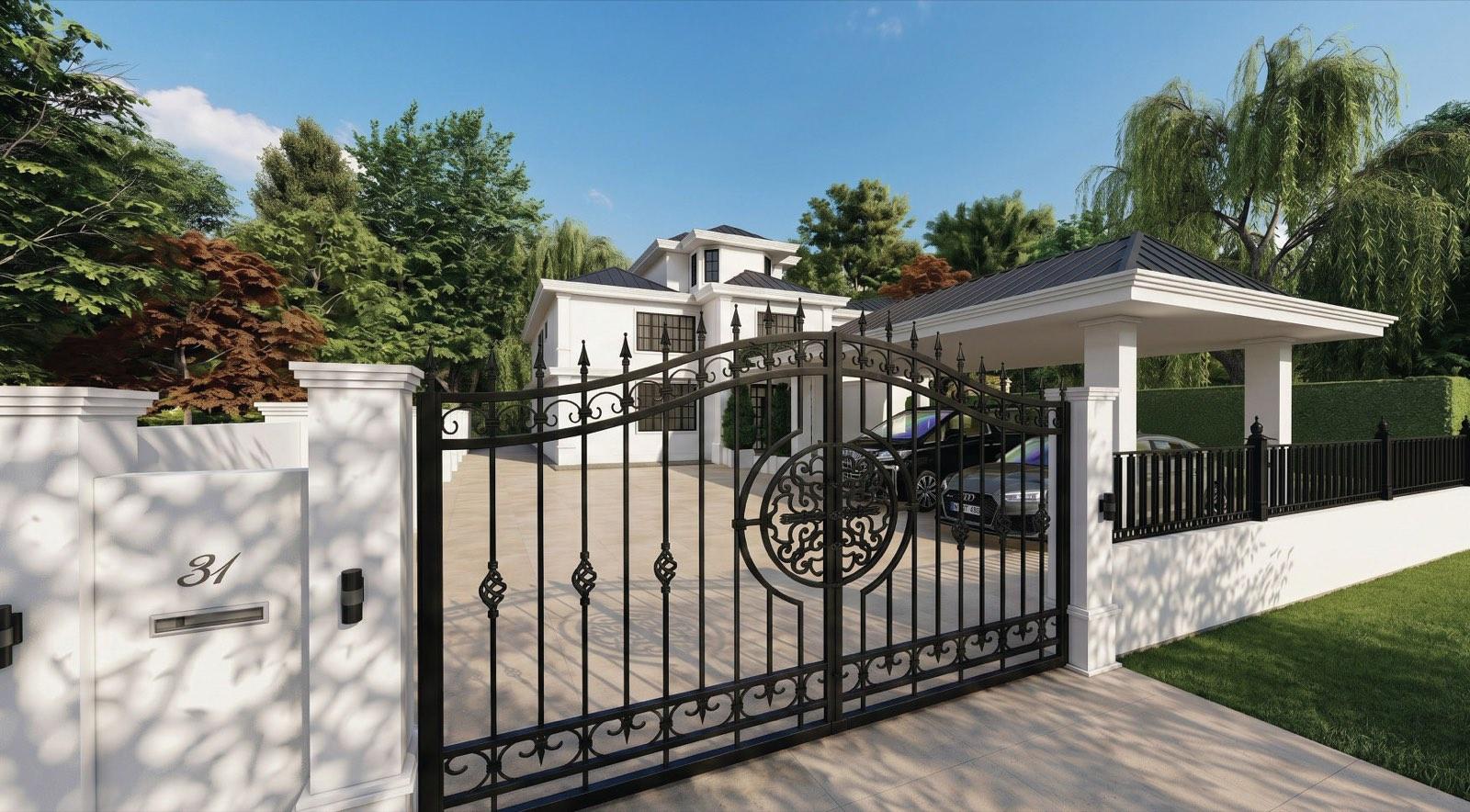 Wrought-iron entrance gate of the KGSAAS villa in Shah Alam, with the white two-storey house and carport pavilion beyond