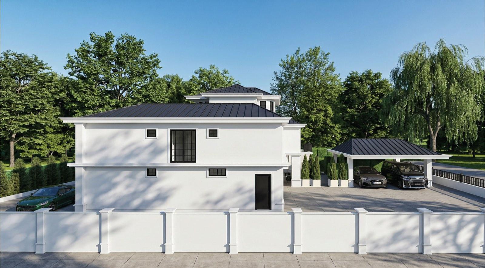 Side elevation of the KGSAAS villa in Shah Alam behind its white boundary wall, with the detached carport pavilion