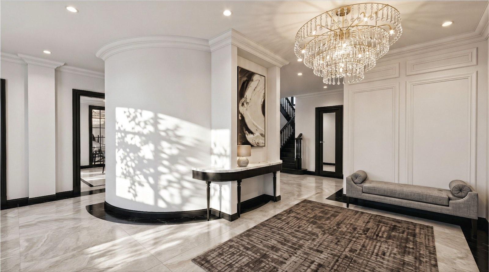 Entrance foyer of the KGSAAS villa in Shah Alam with a crystal chandelier, curved drum wall and marble console table