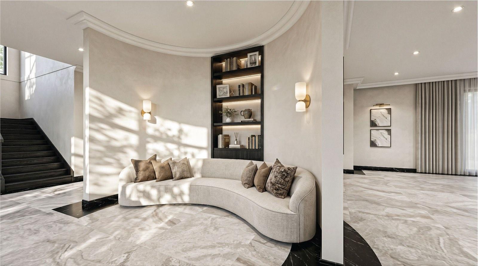 Curved sofa and lit bookshelf niche built into the drum wall of the KGSAAS villa in Shah Alam