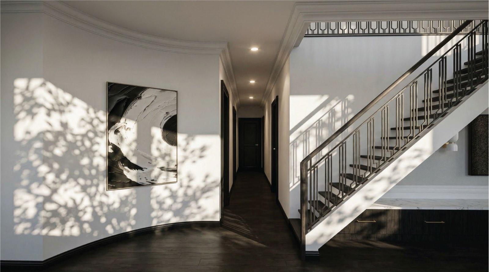 Stair hall of the KGSAAS villa in Shah Alam with a patterned metal balustrade and dark timber floor