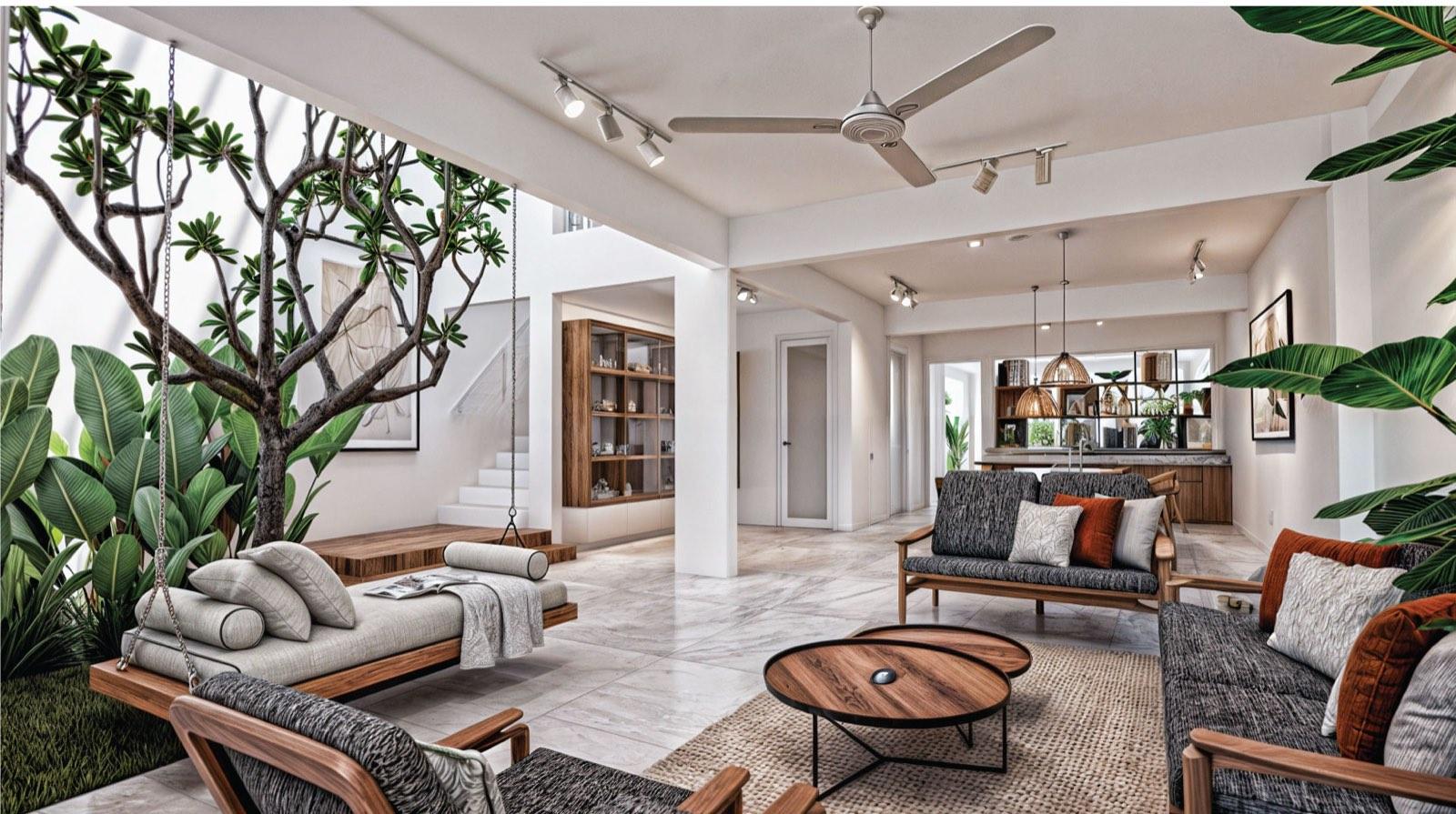 Living room of the Kuala Lumpur terrace house with a hanging daybed beside the courtyard tree and the kitchen beyond