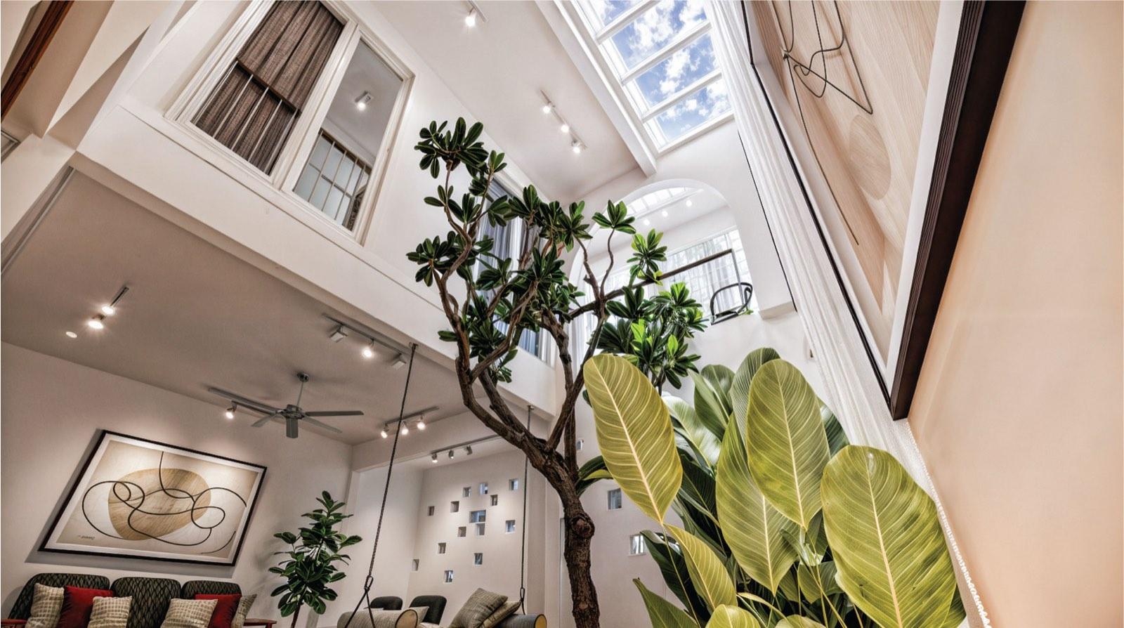 Looking up the atrium of the Kuala Lumpur terrace house to the glazed skylight and mezzanine windows