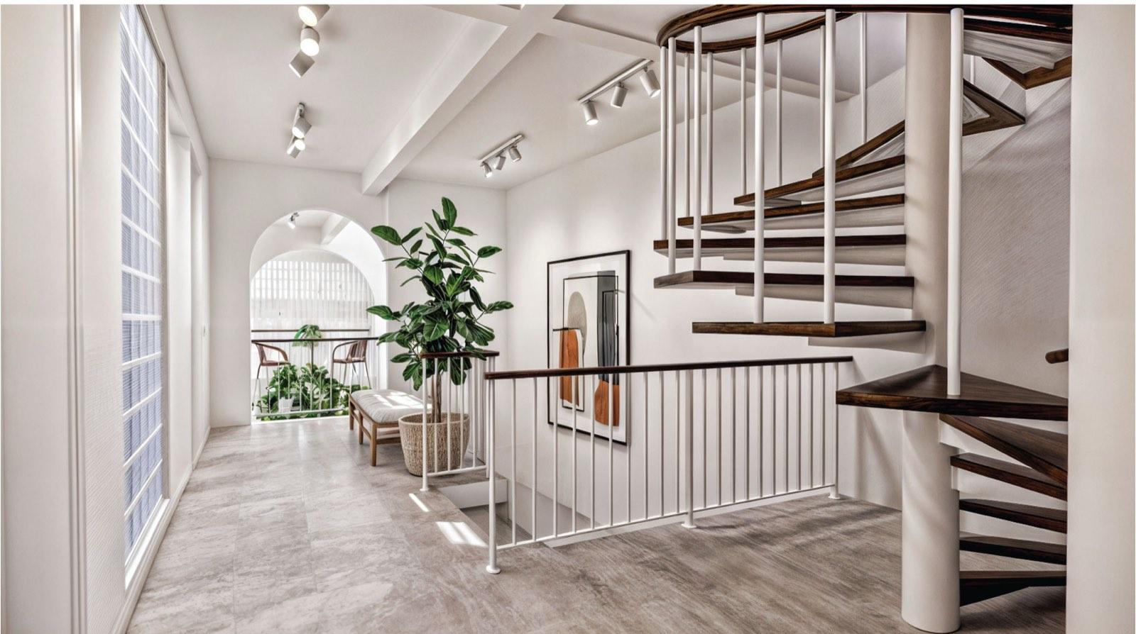 Timber-and-white spiral stair at the landing of the Kuala Lumpur terrace house, rising to the roof terrace