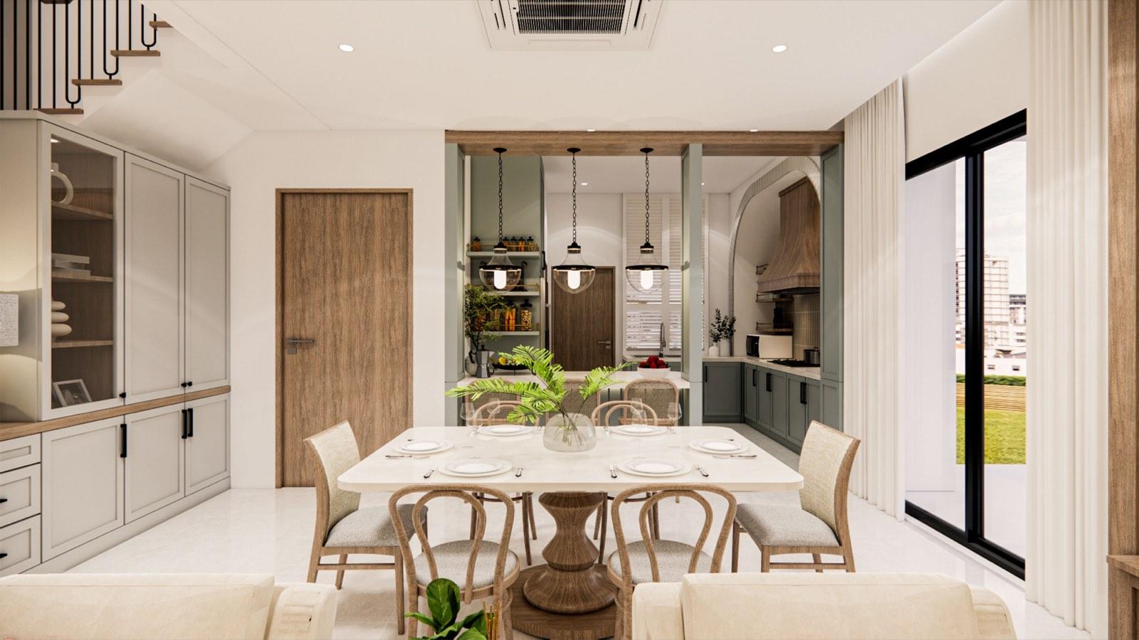 Dining table at the PKNS Kota Puteri show home looking through a timber-framed opening into the sage-green kitchen