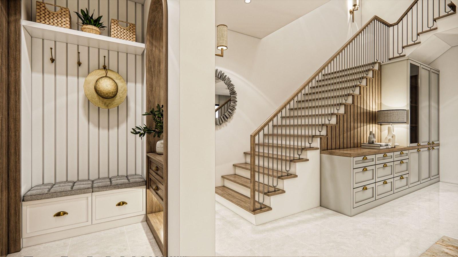 Entry foyer of the PKNS Kota Puteri show home, with a panelled mudroom bench, arched mirror nook and timber stair over built-in drawers