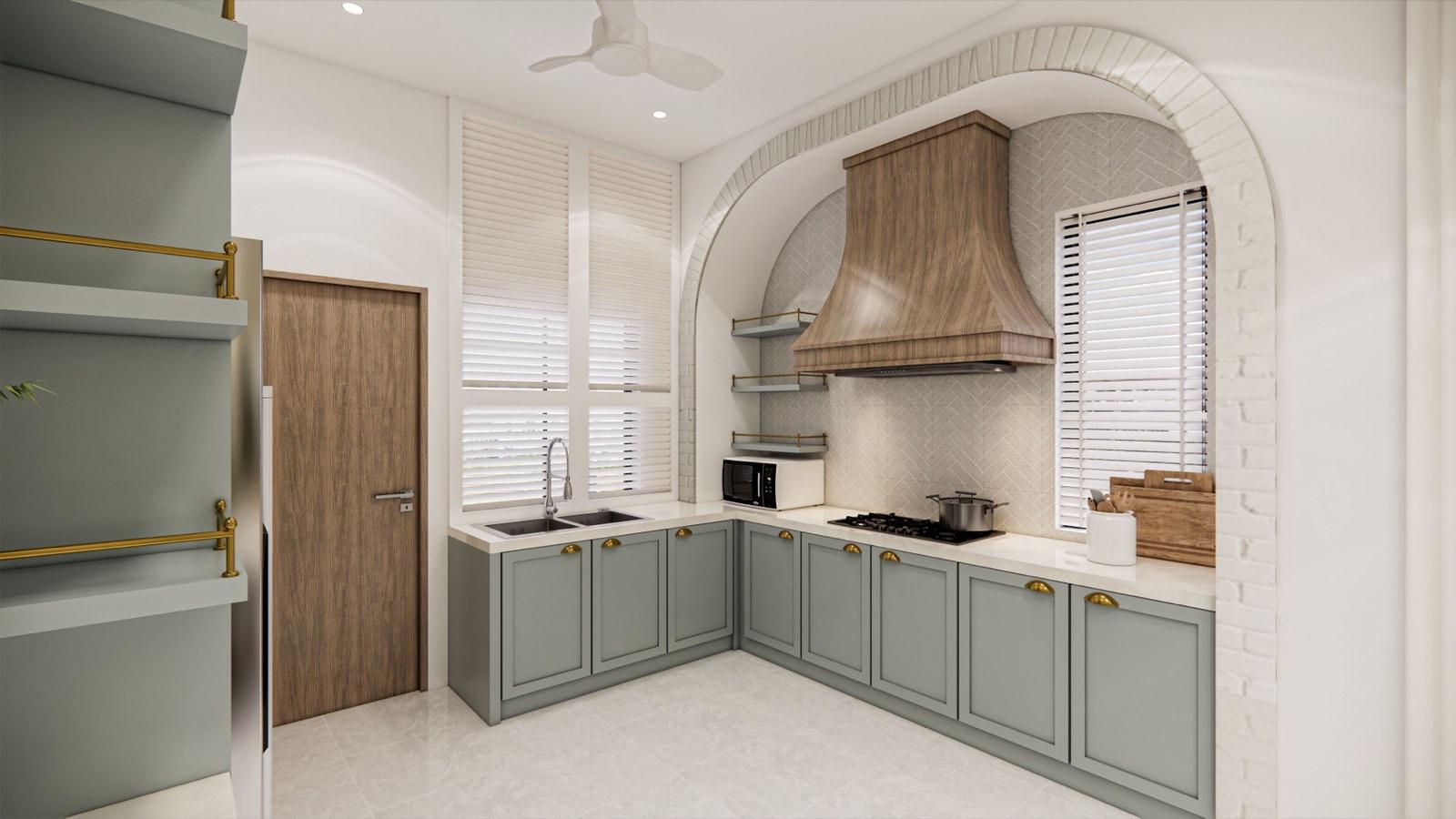 Wet kitchen of the PKNS Kota Puteri show home set inside a painted brick arch, with a timber canopy hood and sage cabinetry