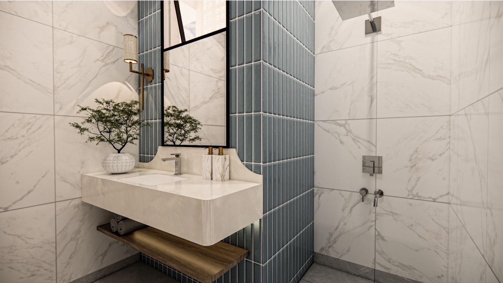 Master bathroom at the PKNS Kota Puteri show home with a floating stone basin against stacked blue-grey tiles and marble walls