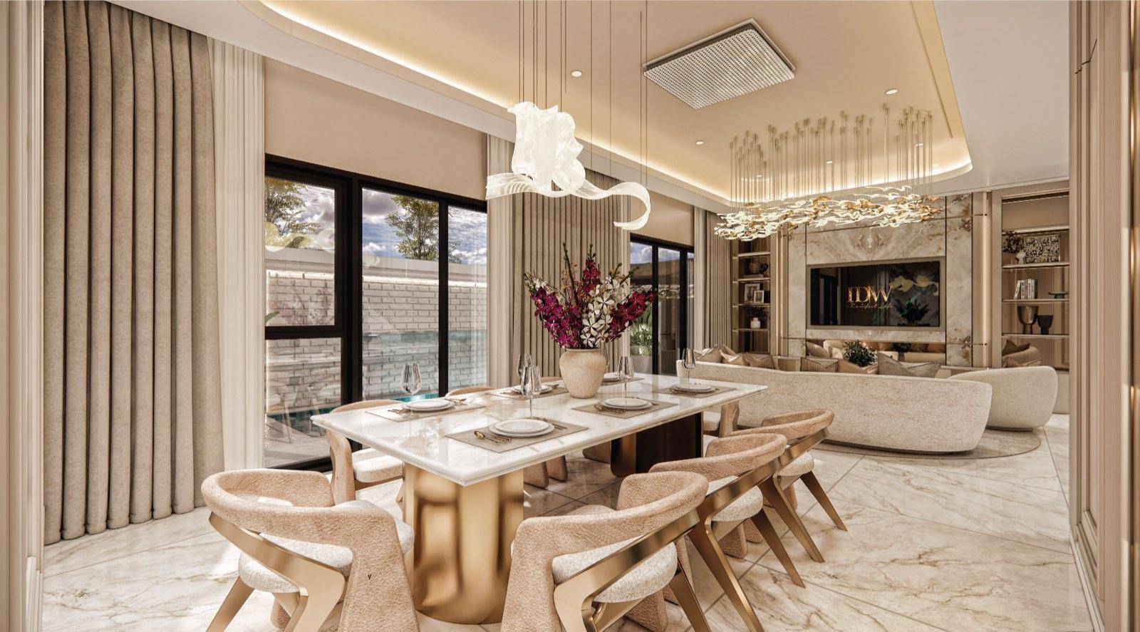 Dining room at Monarc, Gamuda Gardens with a marble table on a gold base, bouclé chairs and a ribbon chandelier