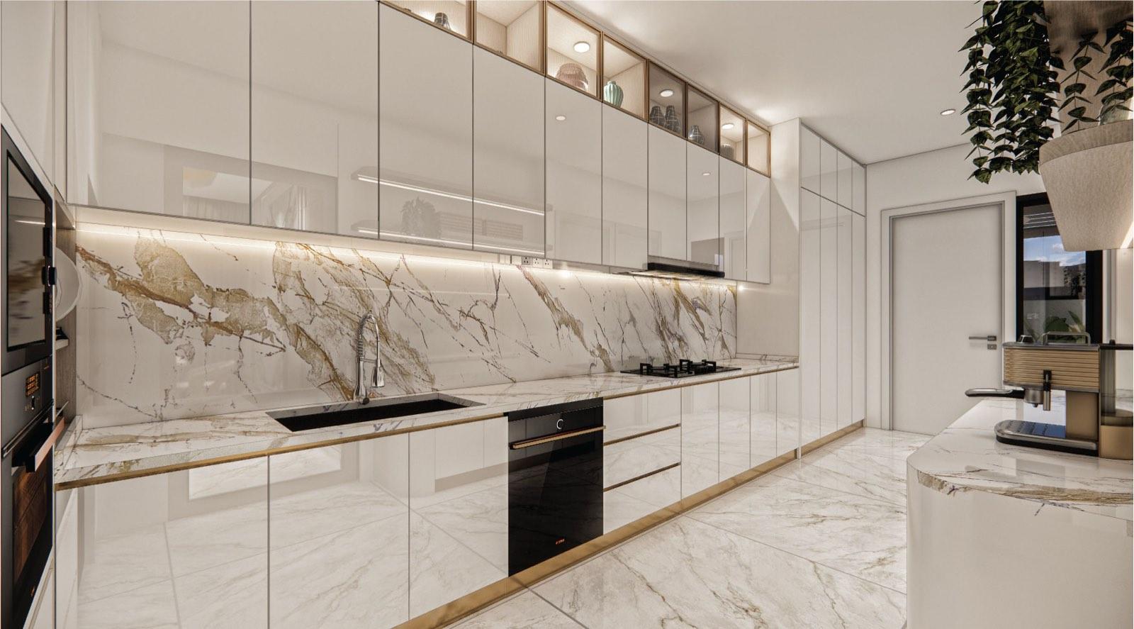 Kitchen worktop at Monarc, Gamuda Gardens with a full calacatta marble splashback, brass trim and lit display cabinets above
