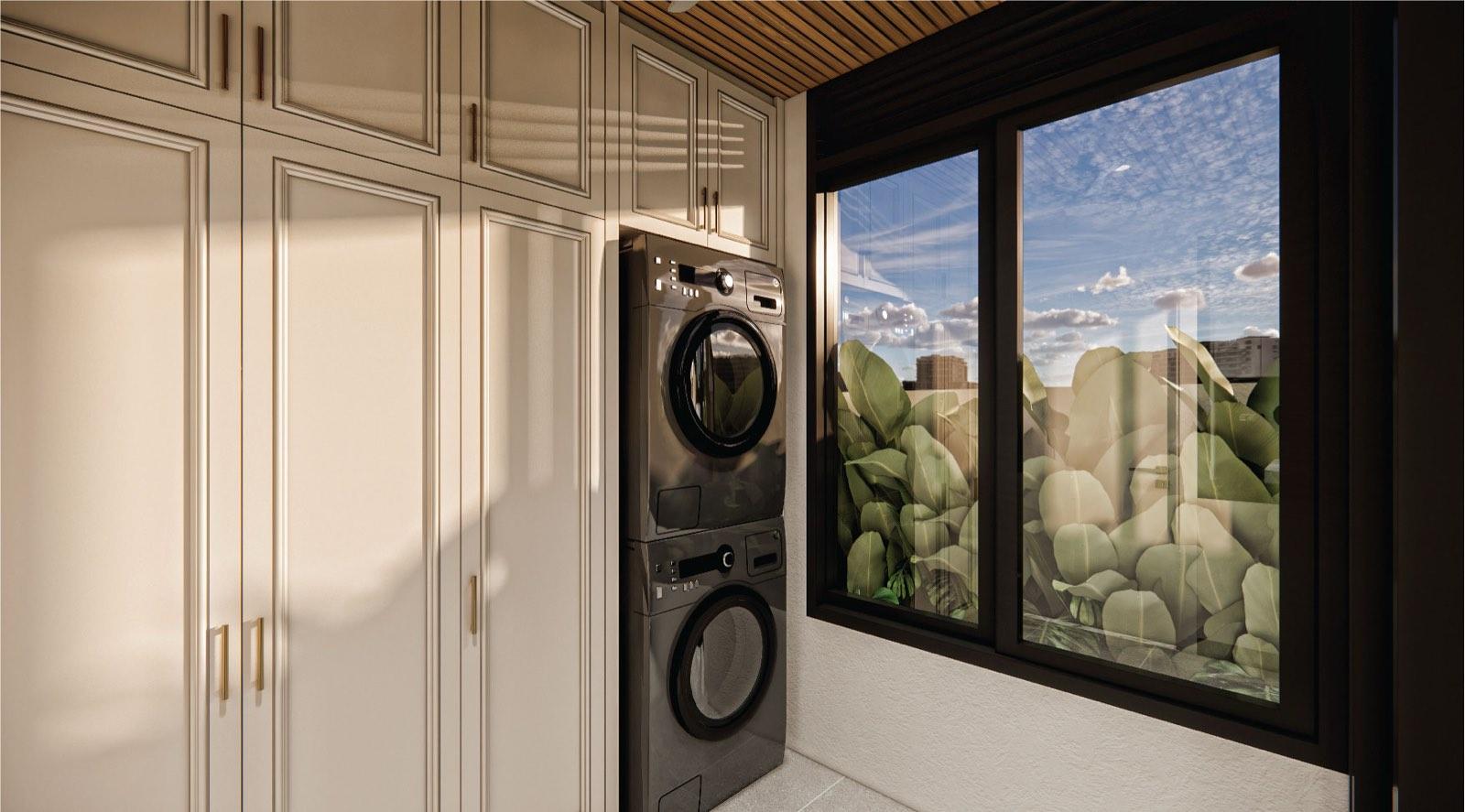 Laundry room at Monarc, Gamuda Gardens with stacked machines, cream panelled cabinetry and a garden window