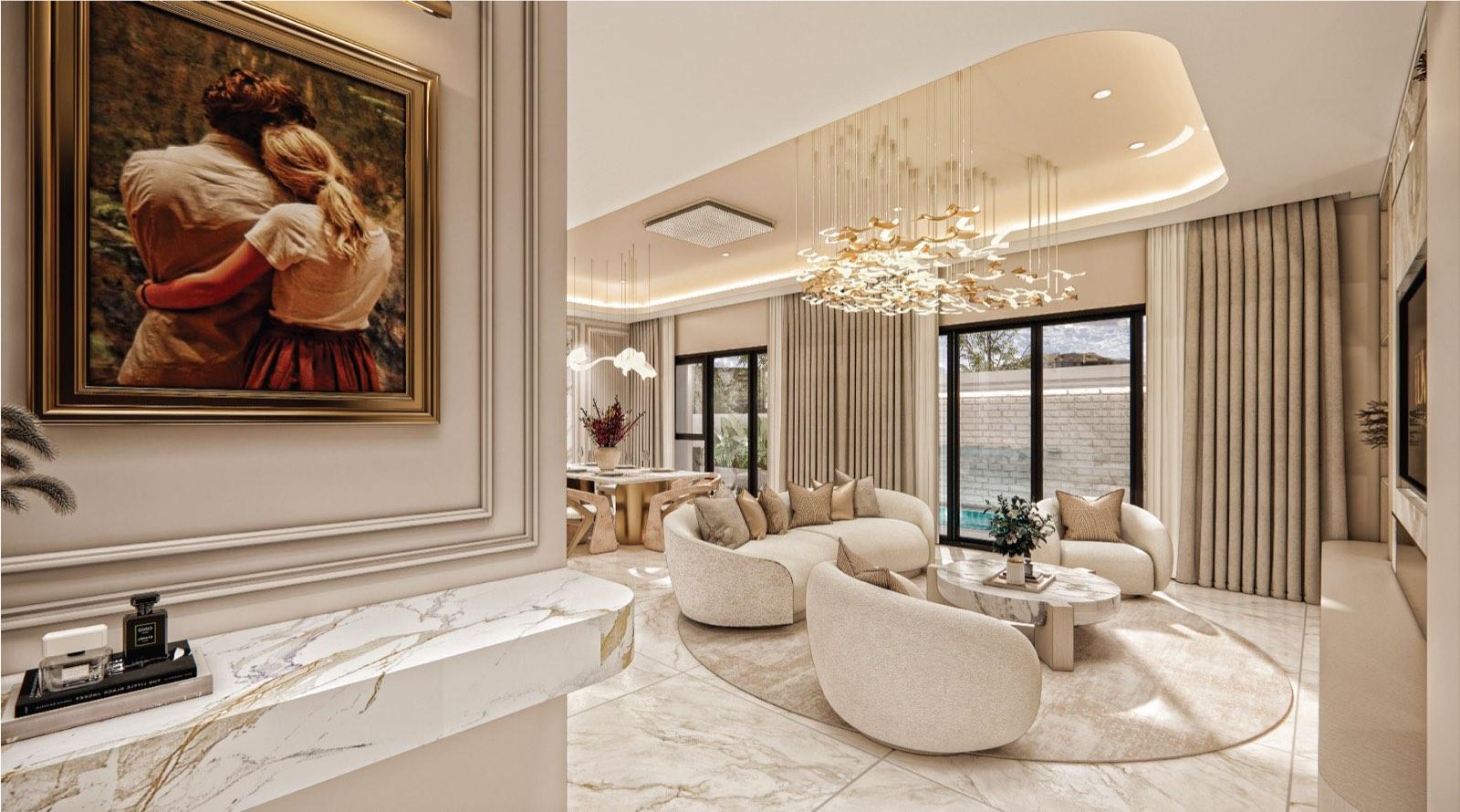 Formal living room at Monarc, Gamuda Gardens with curved cream sofas, a gilded-leaf chandelier and a marble console at the entry