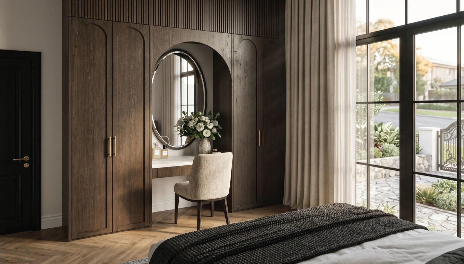 Bedroom in the Taman Paroi Jaya house with arched walnut wardrobes and an oval-mirror vanity nook