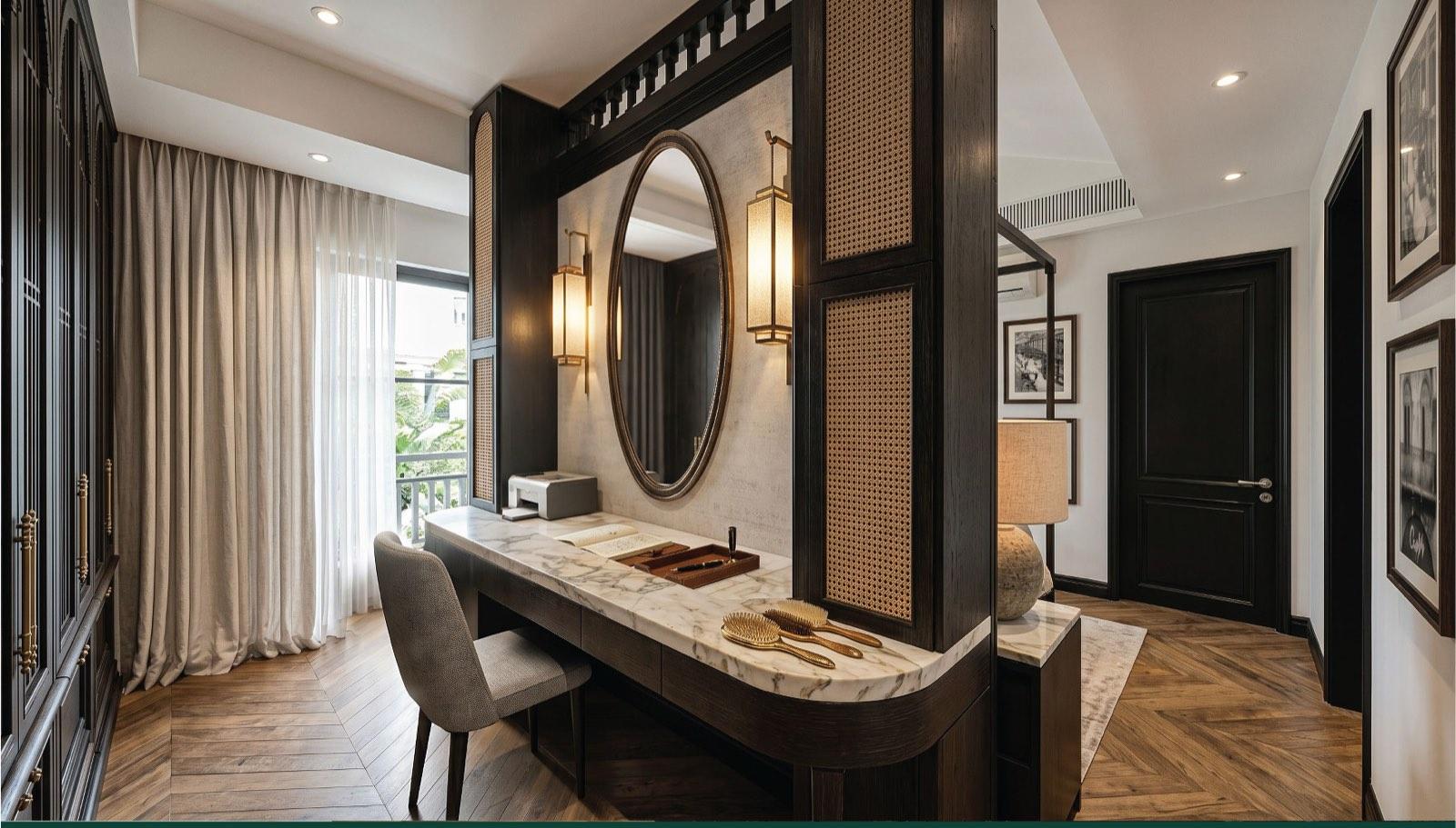 Cane-panelled vanity screen with a marble top and oval mirror dividing the master suite of the Taman Paroi Jaya house