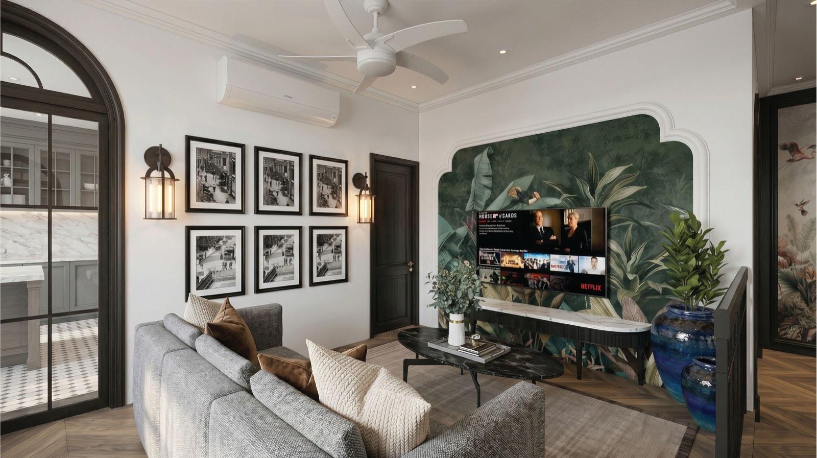 Family room of the Taman Paroi Jaya house with a green botanical mural TV wall and grey sofa