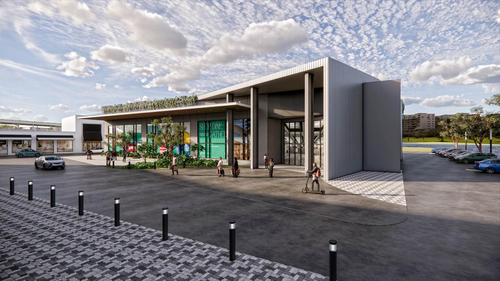 Main entrance portal at PKNS Communal Hub with a green roof edge and glazed shopfront