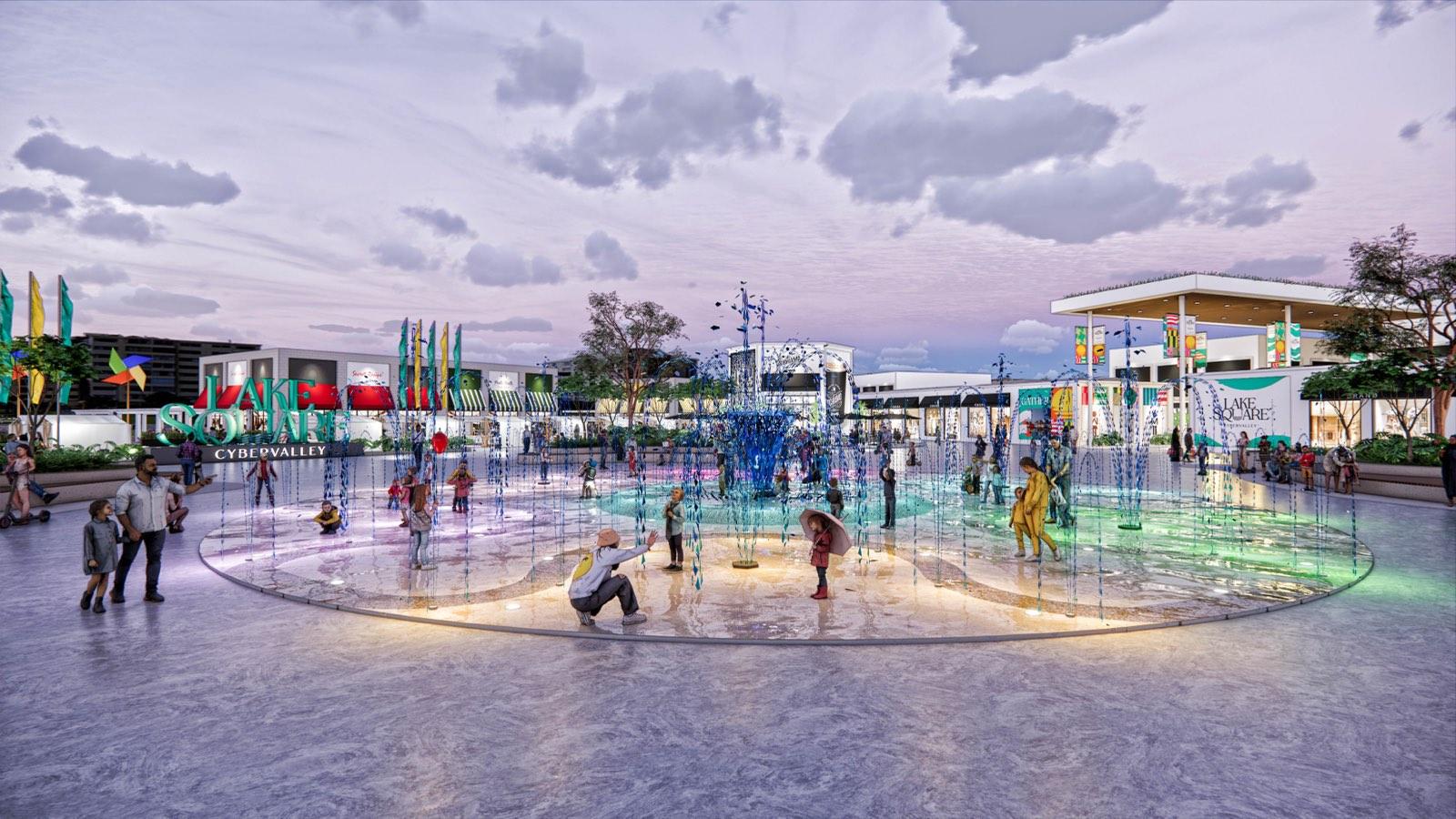 Splash-pad water feature plaza at PKNS Communal Hub at dusk
