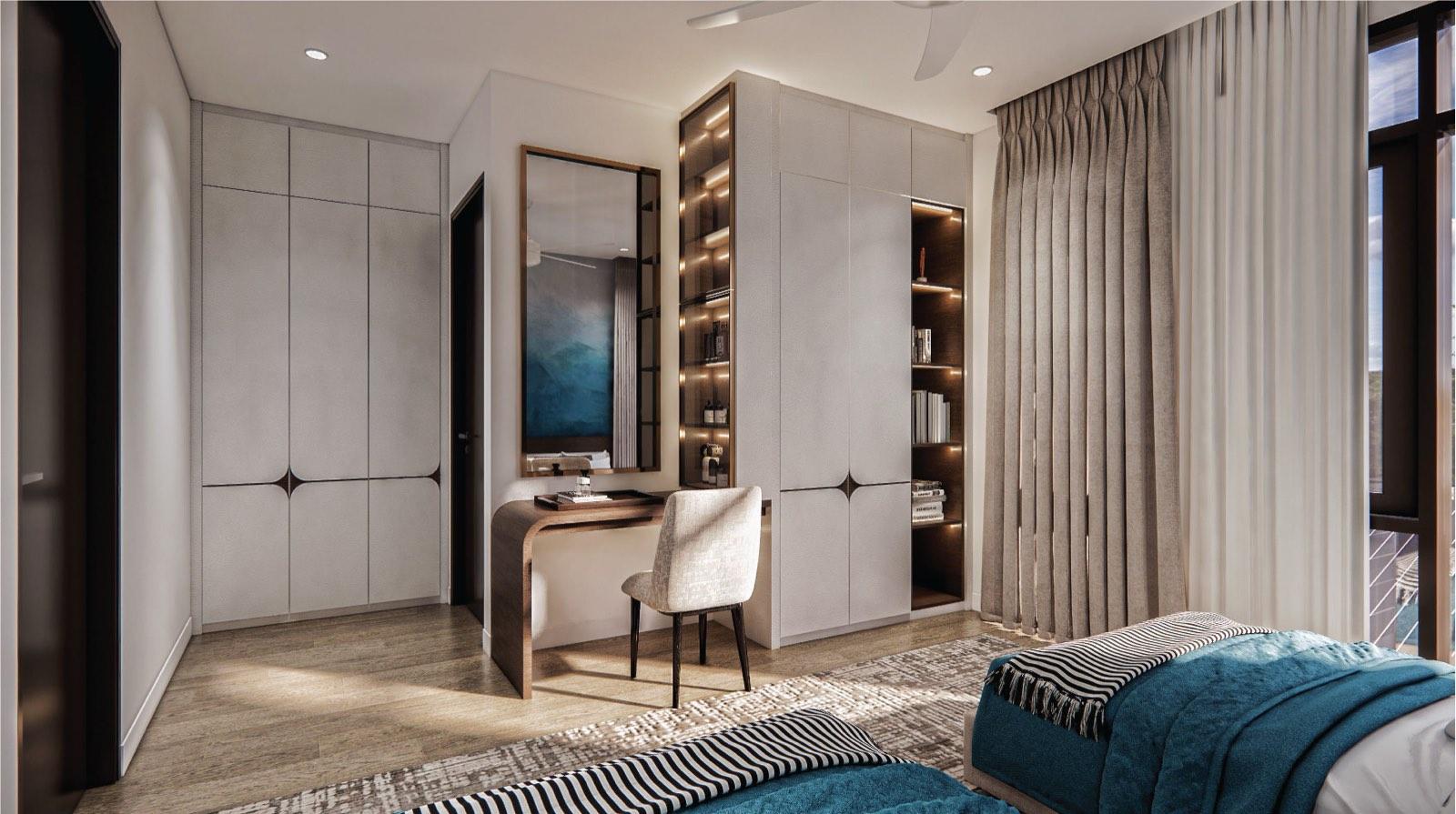 Bedroom at the Putrajaya villa with a curved timber desk, wardrobe wall and teal bedding