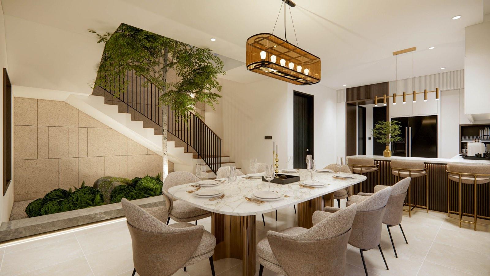 Marble dining table on brass drum legs at the Sime Darby Modern Grandeur show home, beside a planted stair with a birch tree