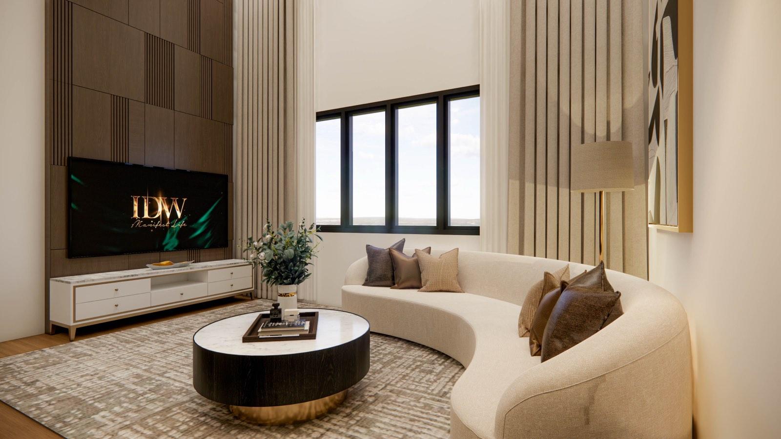 Double-height family lounge at the Sime Darby Modern Grandeur show home with a curved sofa and full-height curtains