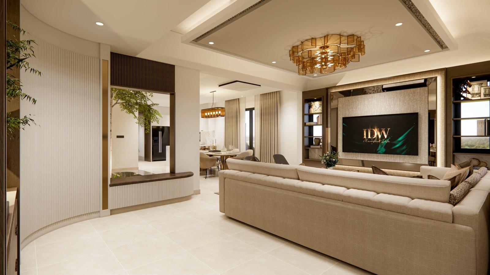 Living room of the Sime Darby Modern Grandeur show home, its beige sofa facing a backlit TV wall under a tiered amber-glass chandelier