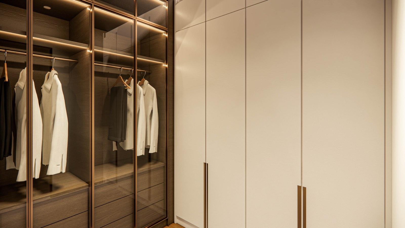 Walk-in wardrobe at the Sime Darby show unit with bronze-framed glass doors and lit timber shelving