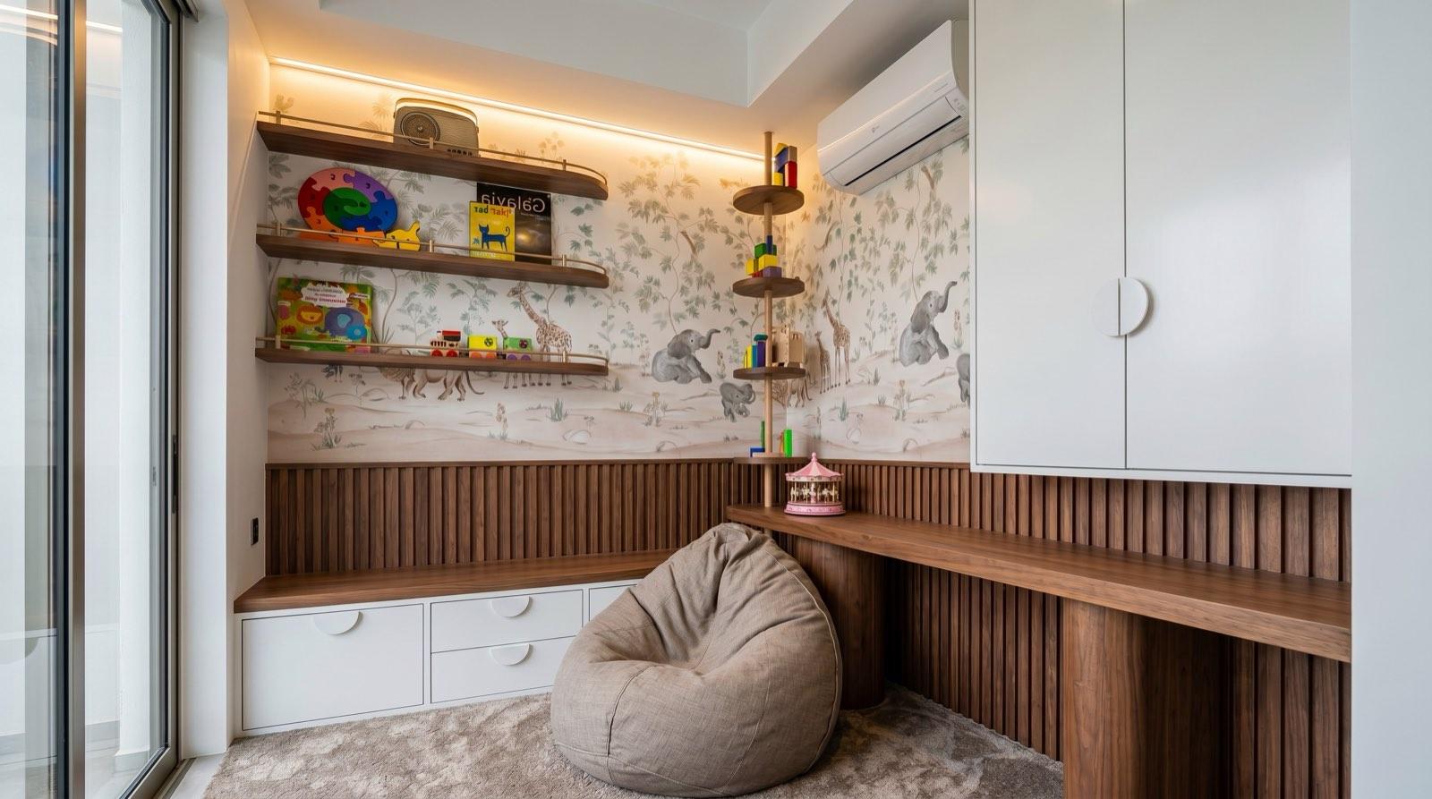 Children's playroom at the Setia Alam residence with a safari mural, fluted walnut panelling and a beanbag corner