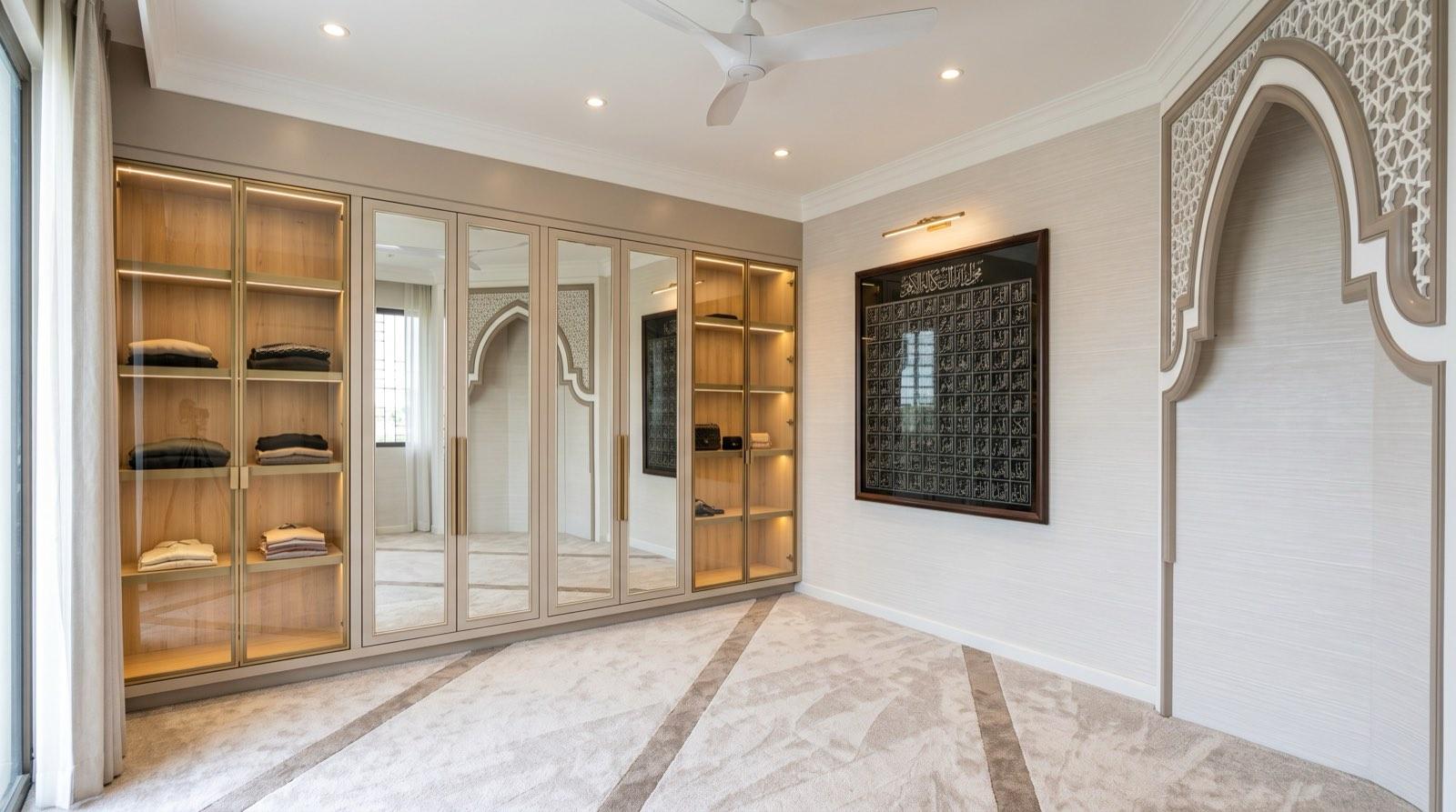 Prayer room at the Setia Alam residence with a carved arch, mirrored wardrobes and a framed Asma ul Husna panel